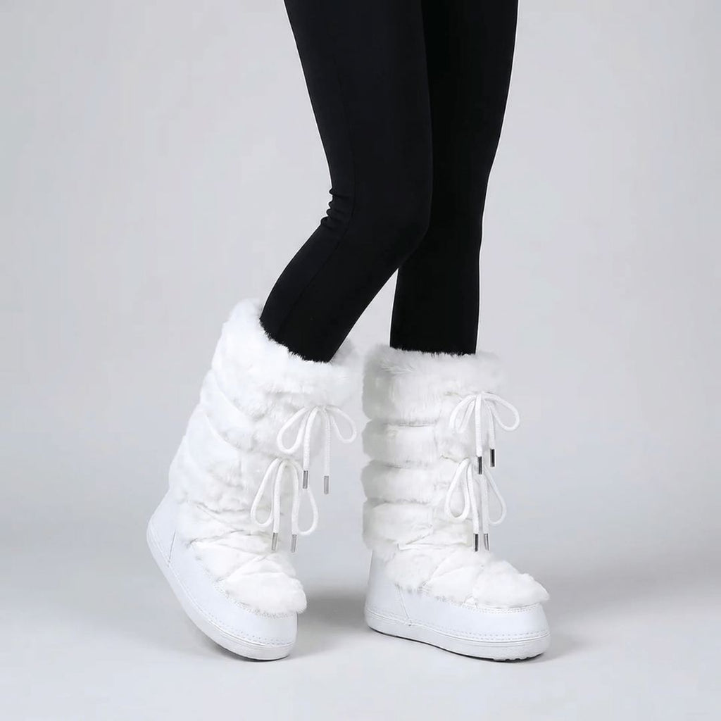Paire de bottes de neige fourrées femme posées sur la neige